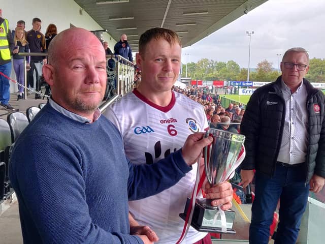 Ballinascreen captain Paul Cleary receives the Derry Intermediate trophy at Owenbeg on Sunday.