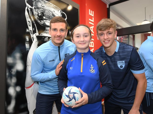 Derry City stars Patrick McEleney and Ciaron Harkin picured with one of the youngsters who enjoyed meeting them at the O'Neills Superstore on Tuesday.