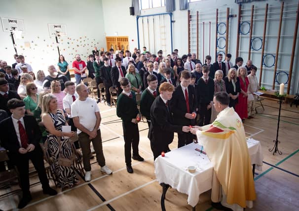 Celebrant Fr. Shaun Doherty accepts candles from Year 12 students during Wednesday's Leavers Mass at St. Joseph's Boys School, Derry. (Photos: Jim McCafferty Photography) : .