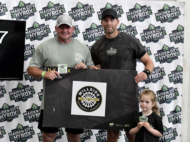 Paddy McGarry with organiser Vincent Sweeney and his daughter Ria at the Maiden City Hyrox IV held at Sean Dolans GAC. Photograph: George Sweeney