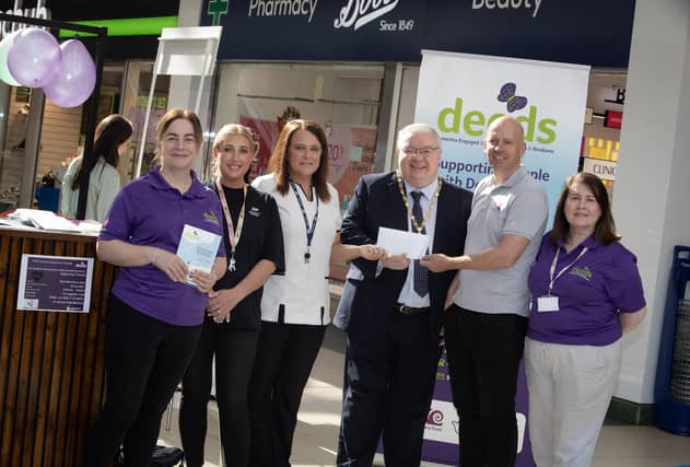 BOOTS CHEQUE FOR DEEDS. . . .Natalie Henry and Rhonda Baldrick, Boots (Foyleside) pictured handing over a cheque for £500 to Deputy Mayor Darren Guy and George McGowan, Project Director, Old Library Trust/DEEDS towards Friday's 'One Stop Shop for Dementia' held in the centre. Included are DEEDS representatives Eilish Brown and Wendy McLaughlin. (Photos: Jim McCafferty Photography)