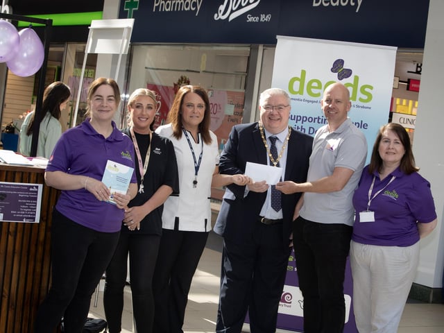 BOOTS CHEQUE FOR DEEDS. . . .Natalie Henry and Rhonda Baldrick, Boots (Foyleside) pictured handing over a cheque for £500 to Deputy Mayor Darren Guy and George McGowan, Project Director, Old Library Trust/DEEDS towards Friday's 'One Stop Shop for Dementia' held in the centre. Included are DEEDS representatives Eilish Brown and Wendy McLaughlin. (Photos: Jim McCafferty Photography)