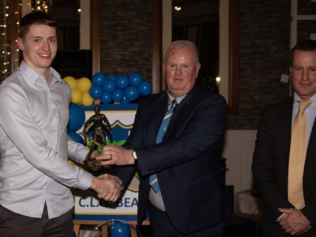 Liam Óg McKinney, U21 Hurling Player of the Year 2024, receives his trophy from Liam Gallagher, Club Chair. On right is Mr. Cormac Hartnett, County Board Hurling Officer. (Photos: Jim McCafferty Photography)