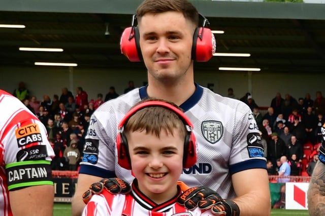 Derry City keeper Brian Maher and mascot Cian Healy pose for the team photograph before the Galway game at Brandywell.
