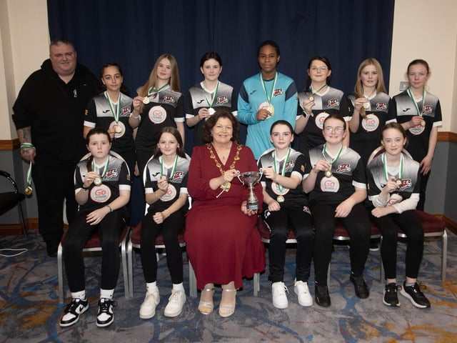 The Mayor of Derry City and Strabane District Council, Patricia Logue presenting the Summer Plate to winners Maiden City FC u-12s. Included is coach Kieran Browne.