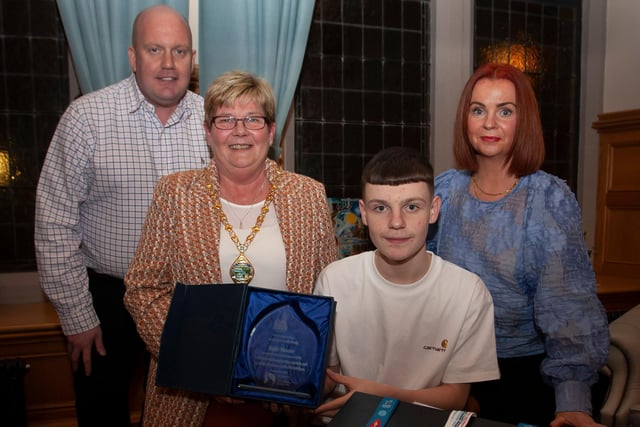 WELL DONE KYLE!. . . .The Deputy Mayor of Derry City and Strabane District Council, Angela Dobbins making a special presentation to Derry teenager Kyle Moore in recognition of his recent success in the WAKO World Championships in Italy and his gold medal success at the Bristol Open, during a reception in his honour at the Mayor’s Parlour, Guildhall on Thursday night last. Included are Kyle’s parents Paul and Shauna.
