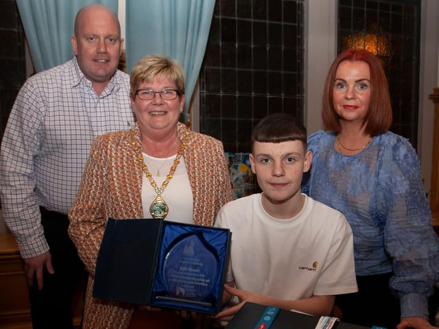 WELL DONE KYLE!. . . .The Deputy Mayor of Derry City and Strabane District Council, Angela Dobbins making a special presentation to Derry teenager Kyle Moore in recognition of his recent success in the WAKO World Championships in Italy and his gold medal success at the Bristol Open, during a reception in his honour at the Mayor’s Parlour, Guildhall on Thursday night last. Included are Kyle’s parents Paul and Shauna.
