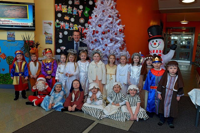 Pupils from Mrs Logue's P1 class at St Eithne's Primary School, who performed their Nativity Play on Wednesday for family and relatives, pictured with Mr Terence McDowell school principal. Photo: George Sweeney. DER2249GS - 06