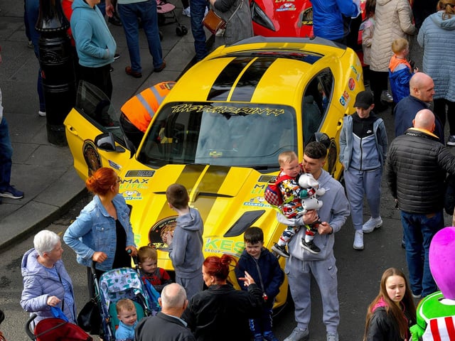 People visit the super cars and American Muscle cars that took part in the Bear Run from Derry’s Shipquay Street to Donegal and Inishowen, on Saturday morning, raising funds for Bumbleance, the Children’s Ambulance Service. Photo: George Sweeney. DER2317GS – 116