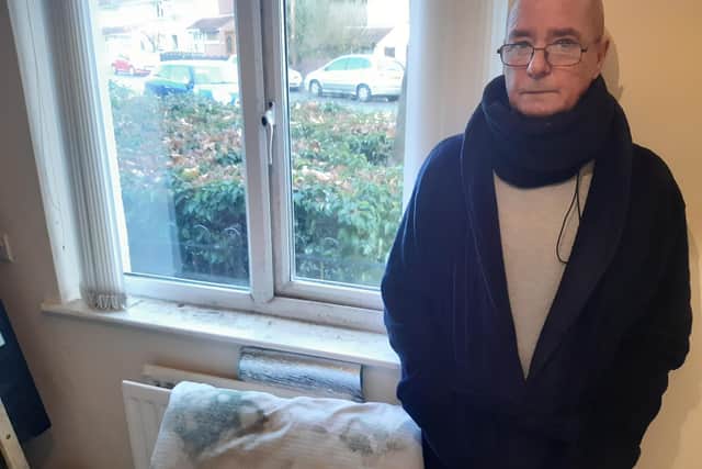 Martin Wade beside a pillow destroyed by damp. He can no longer use his bedroom.