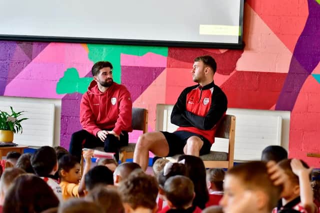 Derry City players Brandon Fleming and Jamie Stott take some questions from pupils at St Therese PS. Photograph by Kevin Morrison.