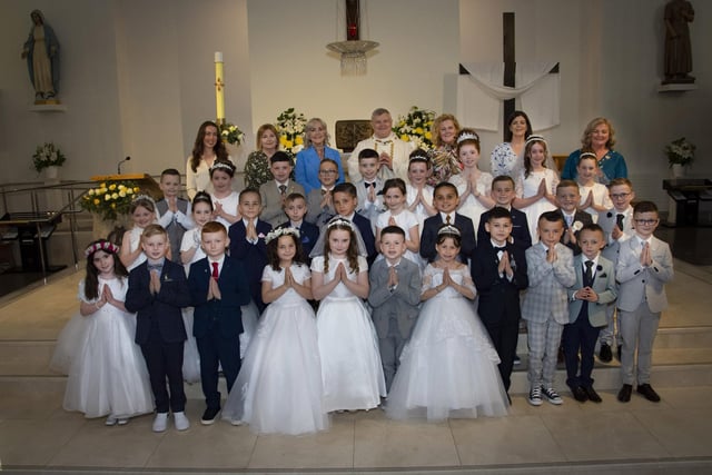 Children from St. John’s Primary School, Derry pictured after receiving the Sacrament of First Holy Communion from Fr. Daniel McFaul at St Mary’s Church, Creggan on Sunday morning. Included back from left are Miss Sarah Dooley,  Mrs Deborah Cunningham, Ms Donna Toland, Fr Daniel McFaul, Mrs Rachel Doherty – Class Teacher, Mrs Feena McGowan and Mrs Geraldine O’Connor, Principal. (Photos: Jim McCafferty Photography)
