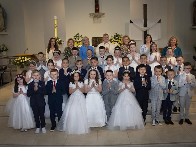Children from St. John’s Primary School, Derry pictured after receiving the Sacrament of First Holy Communion from Fr. Daniel McFaul at St Mary’s Church, Creggan on Sunday morning. Included back from left are Miss Sarah Dooley,  Mrs Deborah Cunningham, Ms Donna Toland, Fr Daniel McFaul, Mrs Rachel Doherty – Class Teacher, Mrs Feena McGowan and Mrs Geraldine O’Connor, Principal. (Photos: Jim McCafferty Photography)
