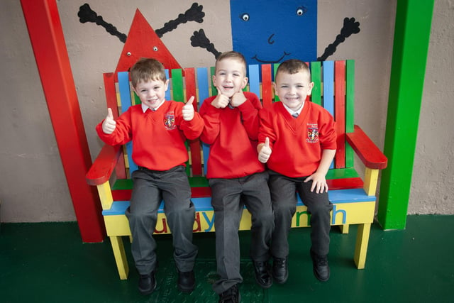On the Buddy Bench at St. Eugene's are P1 pupils Caine, Oisin and Gerard.