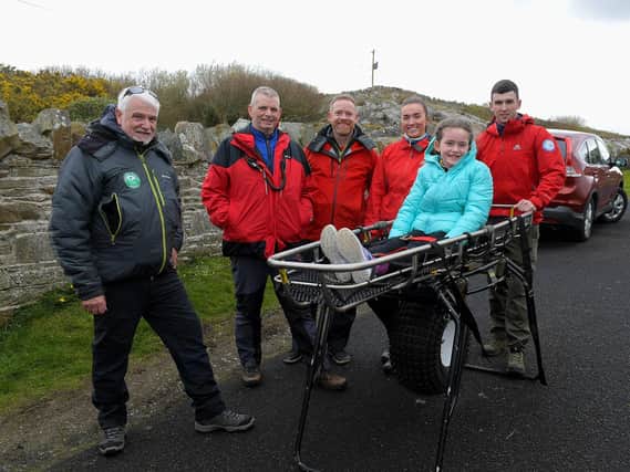 Ali Devine pictured with members of Donegal Mountain Rescue at the Emergency Services Showcase held at Fort Dunree, Inishowen, on Sunday. Photo: George Sweeney
