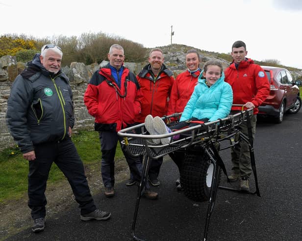 Ali Devine pictured with members of Donegal Mountain Rescue at the Emergency Services Showcase held at Fort Dunree, Inishowen, on Sunday. Photo: George Sweeney