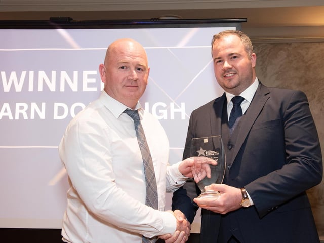 Philip McLaughlin, CLG Charn Domhnaigh collects the Sports Club of the Year Award, sponsored by Express Food Service from Davin Doherty at the Carndonagh Traders Business and Community Awards in the Ballyliffin Lodge Hotel on Saturday night last. Photo Clive Wasson.
