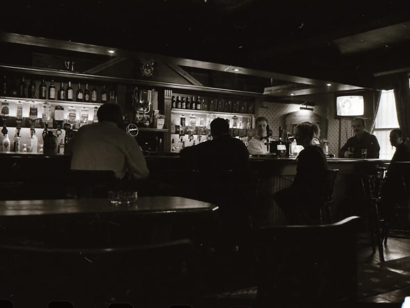 Customers and staff at Doherty's bar beside Castle Gate in Derry city centre.