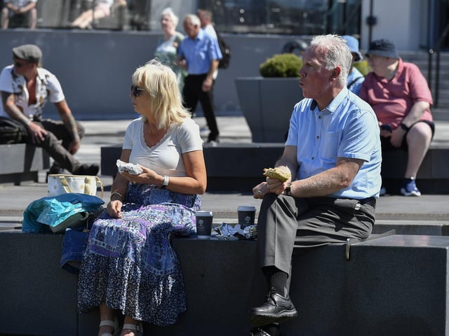 People enjoy the warm sunshine in Ebrington Square. Photo: George Sweeney