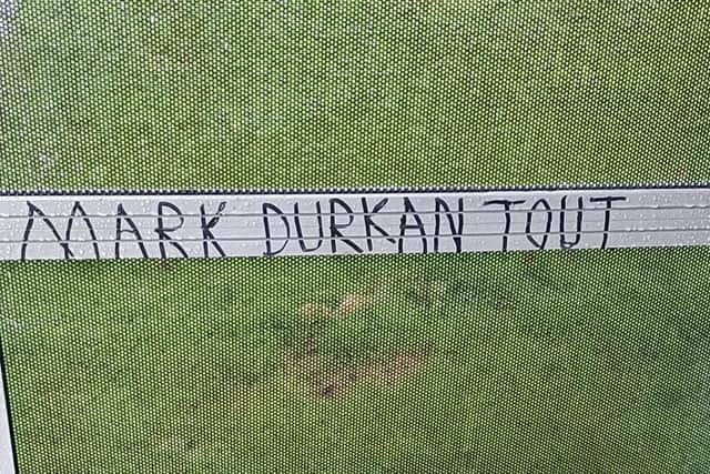Vandals daubed threats against Mark H. Durkan on a bus shelter after he criticised anti-community attacks against Strathfoyle.
