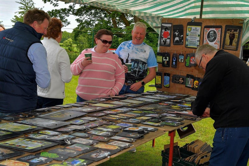 People enjoy the banter at a stall at the Muff Vintage Show held in the Community Park on Sunday. Photo: George Sweeney.  DER2321GS – 08 