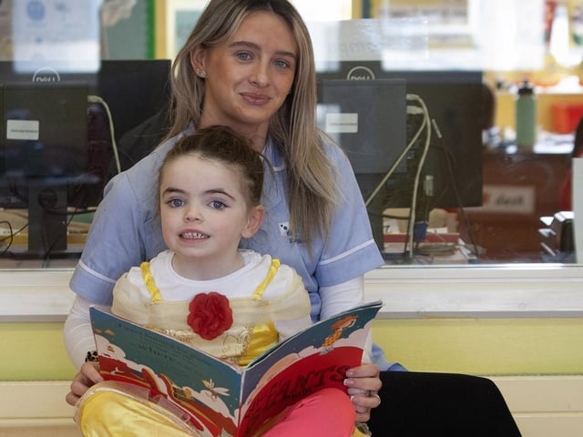 P1 pupil Anna gets some help from Eimear (classroom assistant) on Thursday.