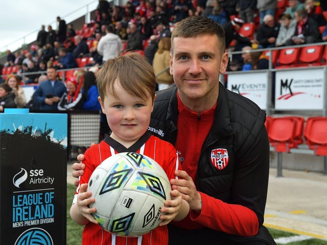 Derry City fan Evan Collins pictured with team captain Patrick McEleney before the game against UCD on Friday evening last. Photo: George Sweeney. DER2320GS – 134