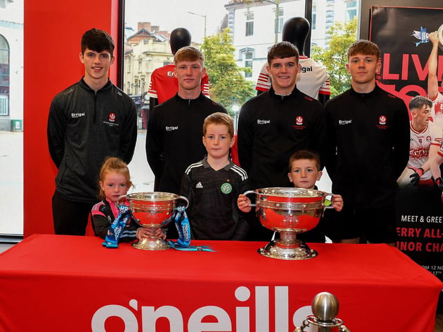 Casey, Cillian and Ciarnan McFeely pictured with members of Derry's All-Ireland Minor Champions team at O'Neill's Superstore last week. Photo: George Sweeney