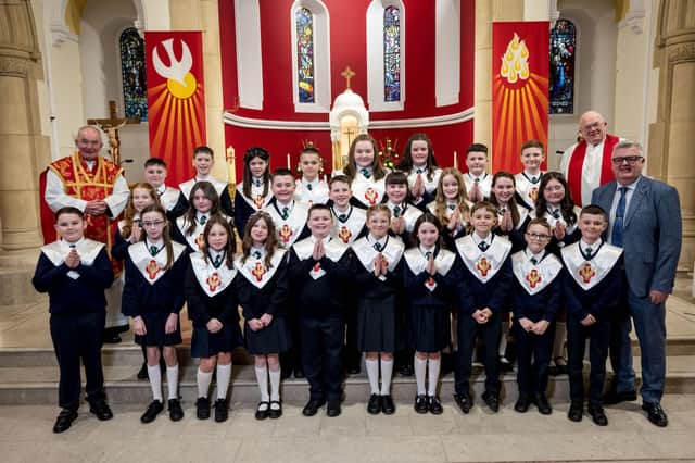 Pupils from Mr Mc Callion's Class, St Patrick's Primary School, pictured at their confirmation at St Patrick's Chapel, Pennyburn. Included, are Fr Noel McDermott, and Fr Michael McCaughey. (Stephen Latimer)
