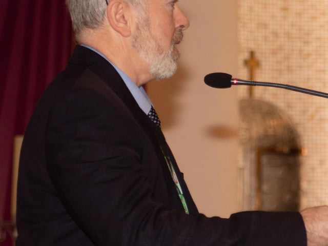 Mr. Paul O'Doherty, Principal, St. Brigid's Primary School, addresses the congregation at Wednesday's Nativity in the church.