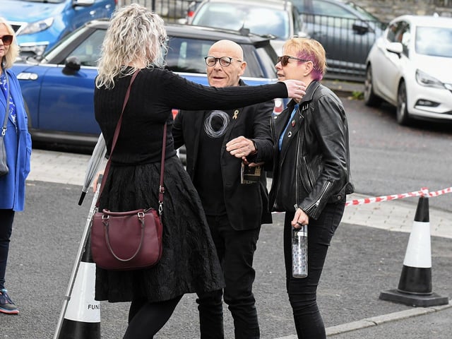 Eamonn McCann and  Goretti Horgan are greeted by a relative of Nell McCafferty at the Long Tower Church on Friday afternoon.  Photo: George Sweeney