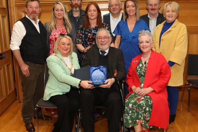 Mayor Sandra Duffy making a presentation to sculptor Maurice Harron, in recognition of his contribution as an art educator and artist in the City and District at a civic reception held in the Guildhall. Included are family and friends. (Photo - Tom Heaney, nwpresspics)