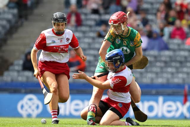 Meath's Ciara Foley and Derry's Niamh Gribbin tussle for possession during the Glen Dimplex All-Ireland Intermediate Camogie Championship Final in Croke Park. (Photo: INPHO/Bryan Keane)
