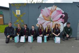 Pictured are the artists involved in the creation of the Glenabbey Art/Mural project, adjacent to Lynch’s Eurospar, Year 10 students from St Brigid’s College alongside Donal Doherty (left) and Mark Payne from the Peaball Collective.  Photo: George Sweeney