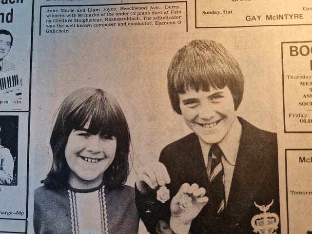 The caption reads: "Anne Marie and Liam Joyce, Beechwood Ave., Derry, winners with 90 marks of the under-12 piano duet at Feis na Gleithre Maighistear, Rosneamhlach. The adjudicator was the well-known composer and conductor, Eamonn O Gallchoir."