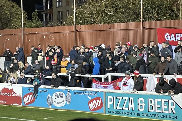 Derry City fans gather behind the goal at Richmond Park.