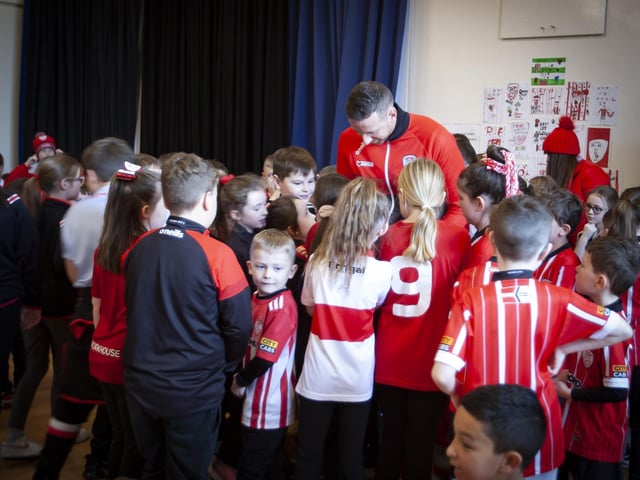 Excited pupils from Steelstown Primary School greet Derry City player Shane McEleney on Tuesday morning ahead of Sunday's FAI Cup Final. (Photo: Jim McCafferty)