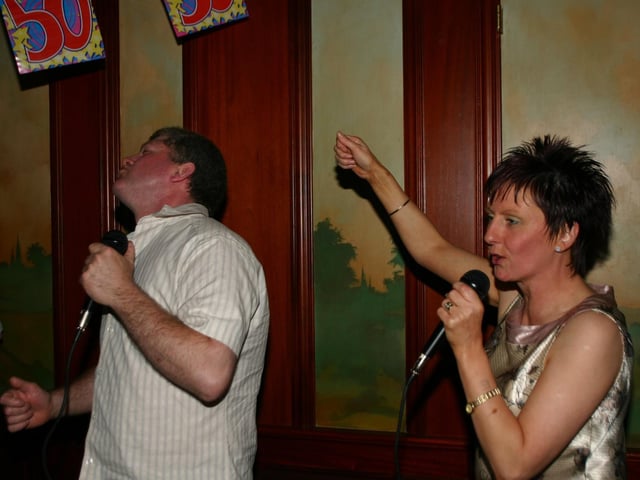 Brendan Donnelly and May Hasson give a Eileen a party song aat her 50th in Rafters 6586dd : Eileen Radcliffe's 50th birthday party.