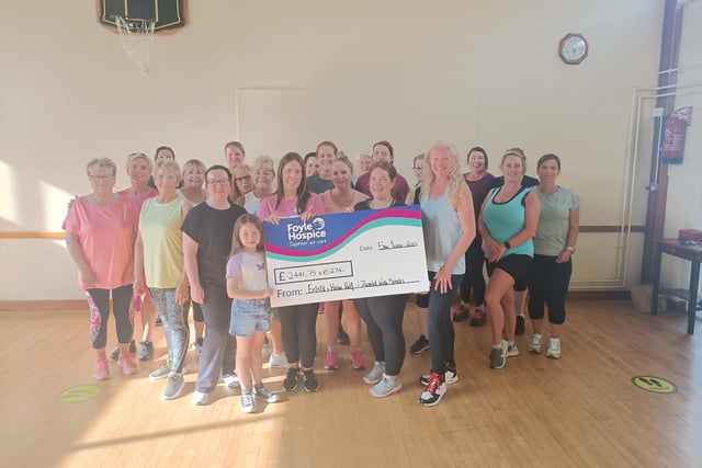 Ladies from Zumba with Sarah in Strabane pictured with Helen, Emma and Ellie Relf with a cheque for Foyle Hospice for £2441.75 & €236, proceeds from a Sponsored Zumbathon held recently in memory of their Grandma Sally Relf.
