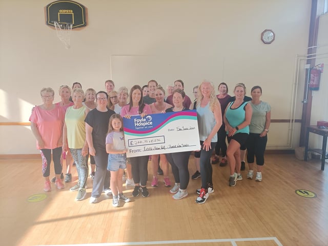 Ladies from Zumba with Sarah in Strabane pictured with Helen, Emma and Ellie Relf with a cheque for Foyle Hospice for £2441.75 & €236, proceeds from a Sponsored Zumbathon held recently in memory of their Grandma Sally Relf.