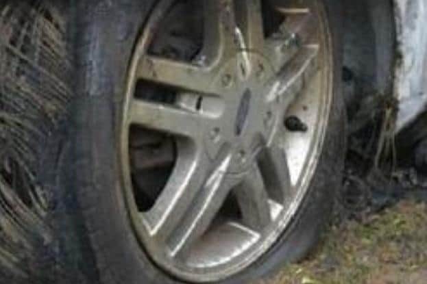 An image of a distinctive alloy wheel on the burned out vehicle.