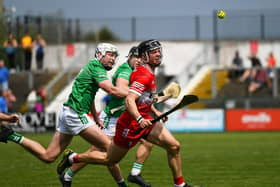 Derry’s Corey O’Reilly and London’s  Cathal O’Carroll contest a loose sliothar. Photo: George Sweeney