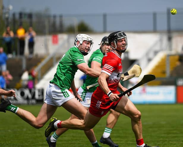 Derry’s Corey O’Reilly and London’s  Cathal O’Carroll contest a loose sliothar. Photo: George Sweeney