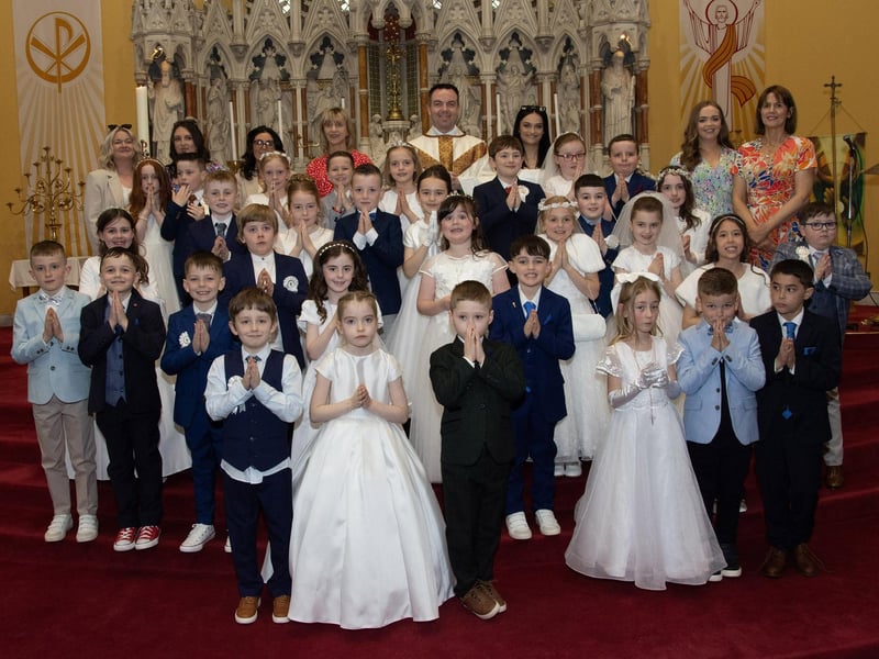 Children from Oakgrove Primary School who received the Sacrament of First Holy Communion from Fr. Patrick Lagan at St. Columba's Church, Chapel Road Waterside on Friday last. Included at back are staff from the school. (Photos: Jim McCafferty Photography)