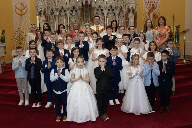 Children from Oakgrove Primary School who received the Sacrament of First Holy Communion from Fr. Patrick Lagan at St. Columba's Church, Chapel Road Waterside on Friday last. Included at back are staff from the school. (Photos: Jim McCafferty Photography)