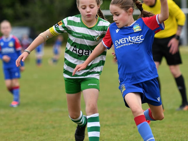 Top Of The Hill Celtic's Aoife Ferguson in a race for the ball with Linfield forward Neiko Sloane during their girls under-9's match.