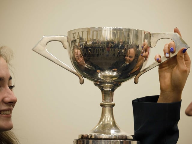 Holly Bradley and Erin Irvine students admire their cup from Thornhill College Derry who won the Sacred Music Post Primary Award  at Feis Ceoil 2023