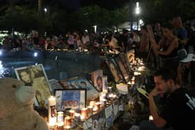 People mark the first anniversary of the October 7, 2023 attacks, in the Israeli coastal city of Tel Aviv on October 7, 2024. (Photo by GIL COHEN-MAGEN / AFP) (Photo by GIL COHEN-MAGEN/AFP via Getty Images)