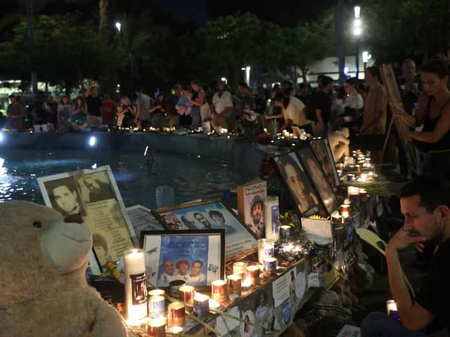 People mark the first anniversary of the October 7, 2023 attacks, in the Israeli coastal city of Tel Aviv on October 7, 2024. (Photo by GIL COHEN-MAGEN / AFP) (Photo by GIL COHEN-MAGEN/AFP via Getty Images)