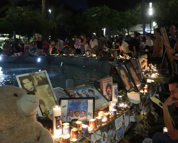 People mark the first anniversary of the October 7, 2023 attacks, in the Israeli coastal city of Tel Aviv on October 7, 2024. (Photo by GIL COHEN-MAGEN / AFP) (Photo by GIL COHEN-MAGEN/AFP via Getty Images)